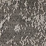 A detailed texture shot of a salt-and-pepper woven material, highlighting the individual loops of light and dark threads.