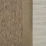 Brown-textured-rug-with-a-wide-fabric-border-resting-on-a-light-wood-floor.