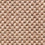 Close-up of a light tan and cream natural fiber rug.