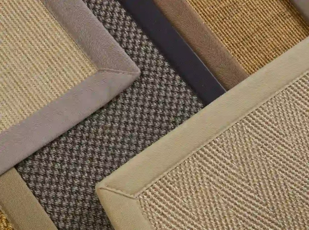 Collection of natural fiber rug samples with fabric borders