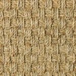 High-resolution shot of a chunky basketweave pattern on a natural jute rug.