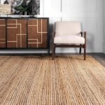 Stylish living room with a natural jute rug, mid-century armchair, and geometric wooden sideboard.