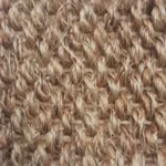 jute-rug-featuring-a-mix-of-warm-tan-and-darker-brown-fibers.