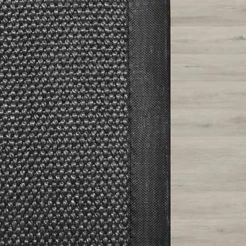 dark-grey-textured-rug-with-a-black-border-on-light-wood-flooring